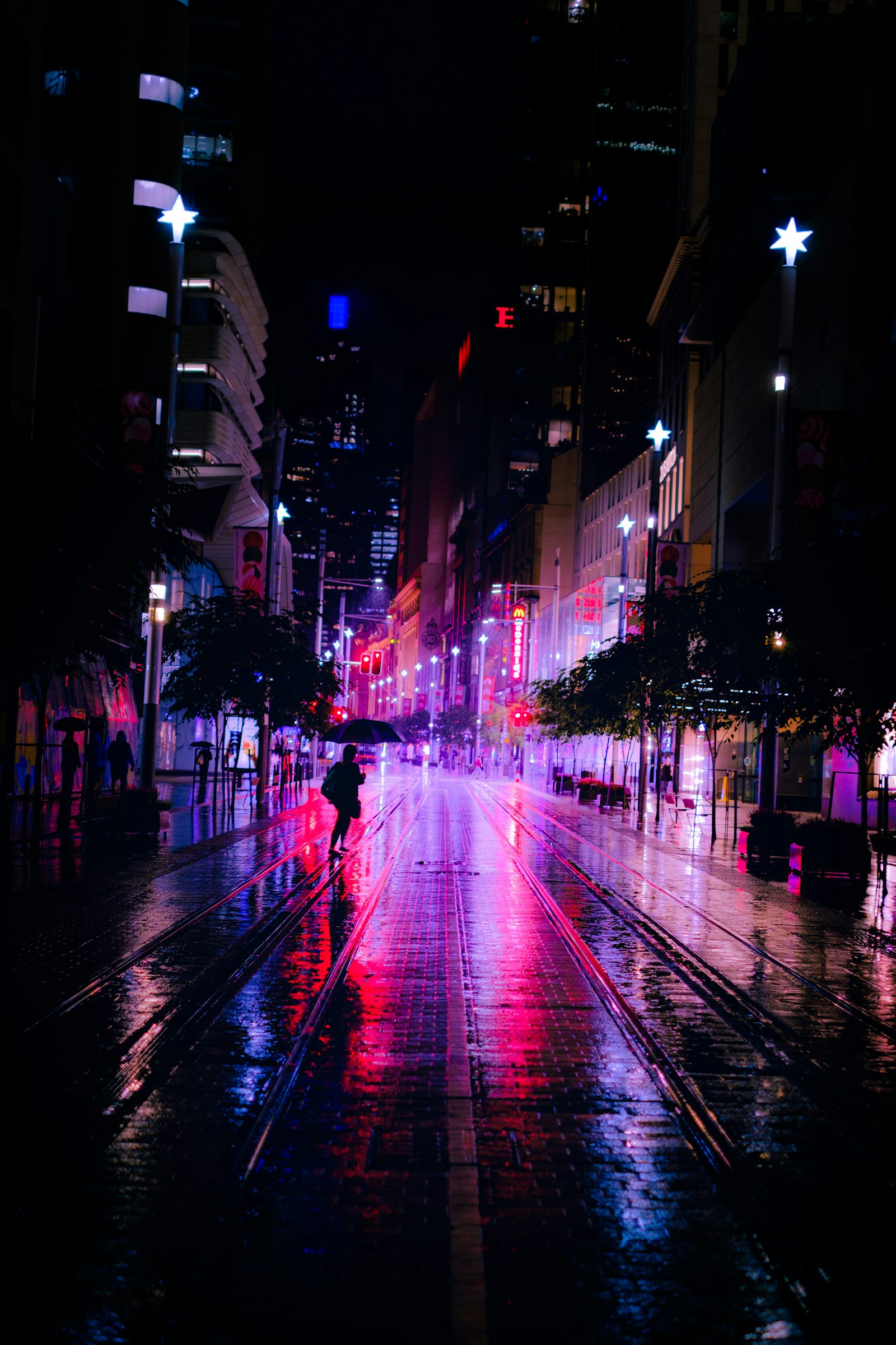 Rainy street with purple neon reflections