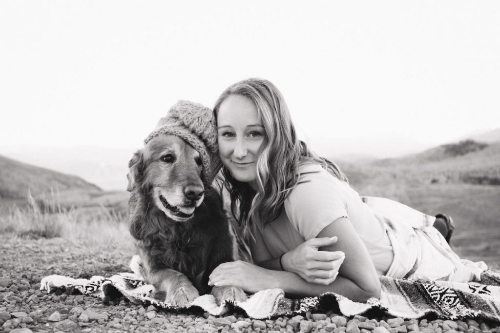 photo of a woman and a dog wearing a hat